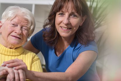 Ältere Frau und jüngere weibliche Pflegekraft